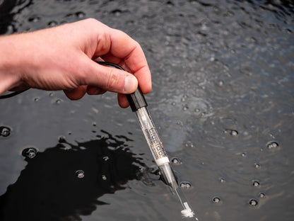 Bluelab pH Probe being dipped into a reservoir by hand